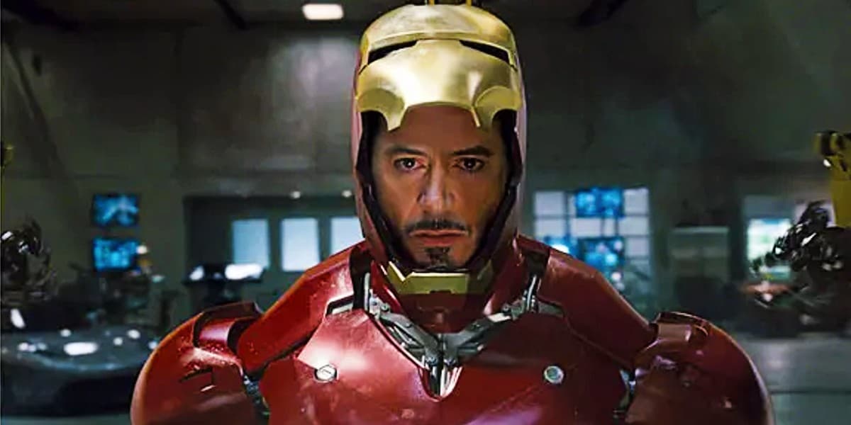 Robert Downey Jr. in an iron man suit with the helmet partially open, revealing their face.
