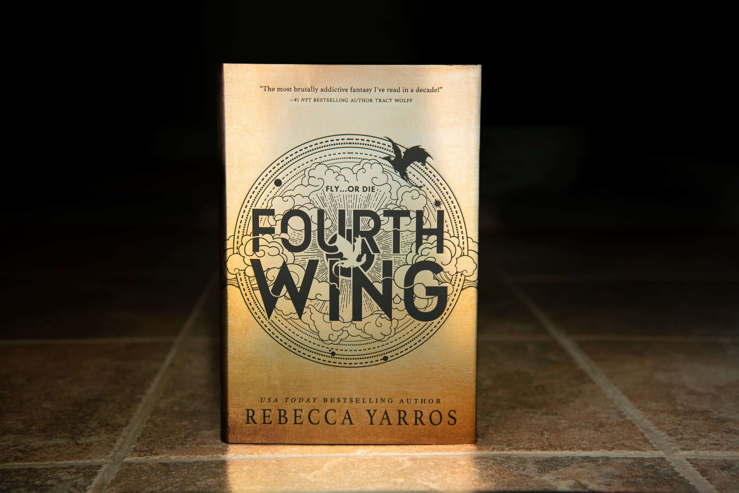 Shutterstock image of the first book of the Fourth Wing series standing up.