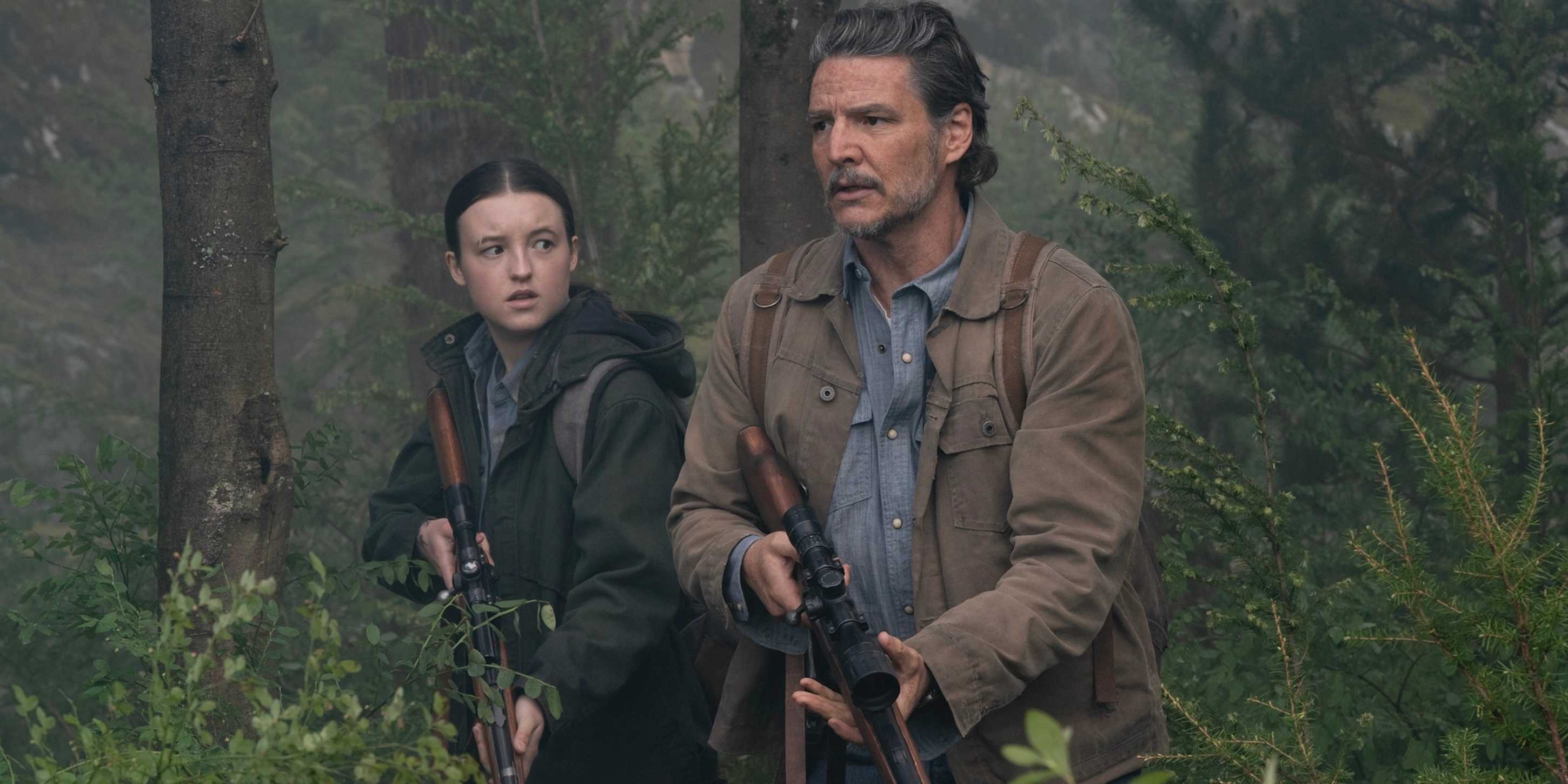 Joel Miller (Pedro Pascal) and Ellie Williams (Bella Ramsey) walking through the woods on The Last of Us