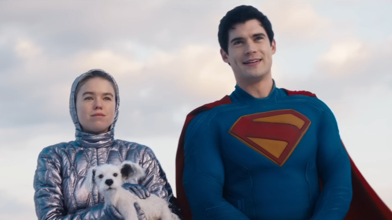 Milly Alcock as Kara Zor-El holding Krypto standing next to David Corenswet's Superman in Supergirl (2026)
