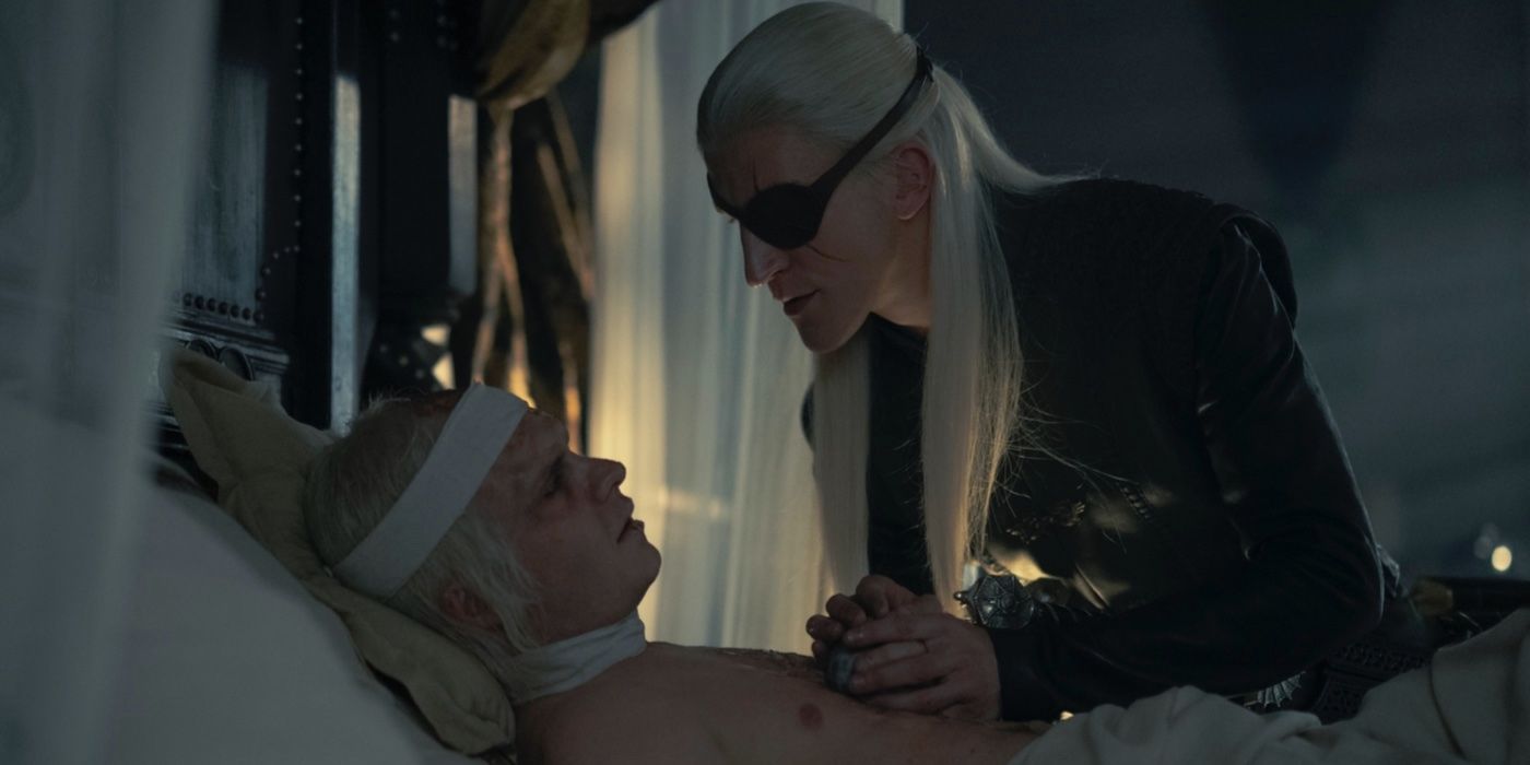 Aemond (Ewan Mitchell) is holding bedridden Aegon's (Tom Glynn-Carney) hand on House of the Dragon.